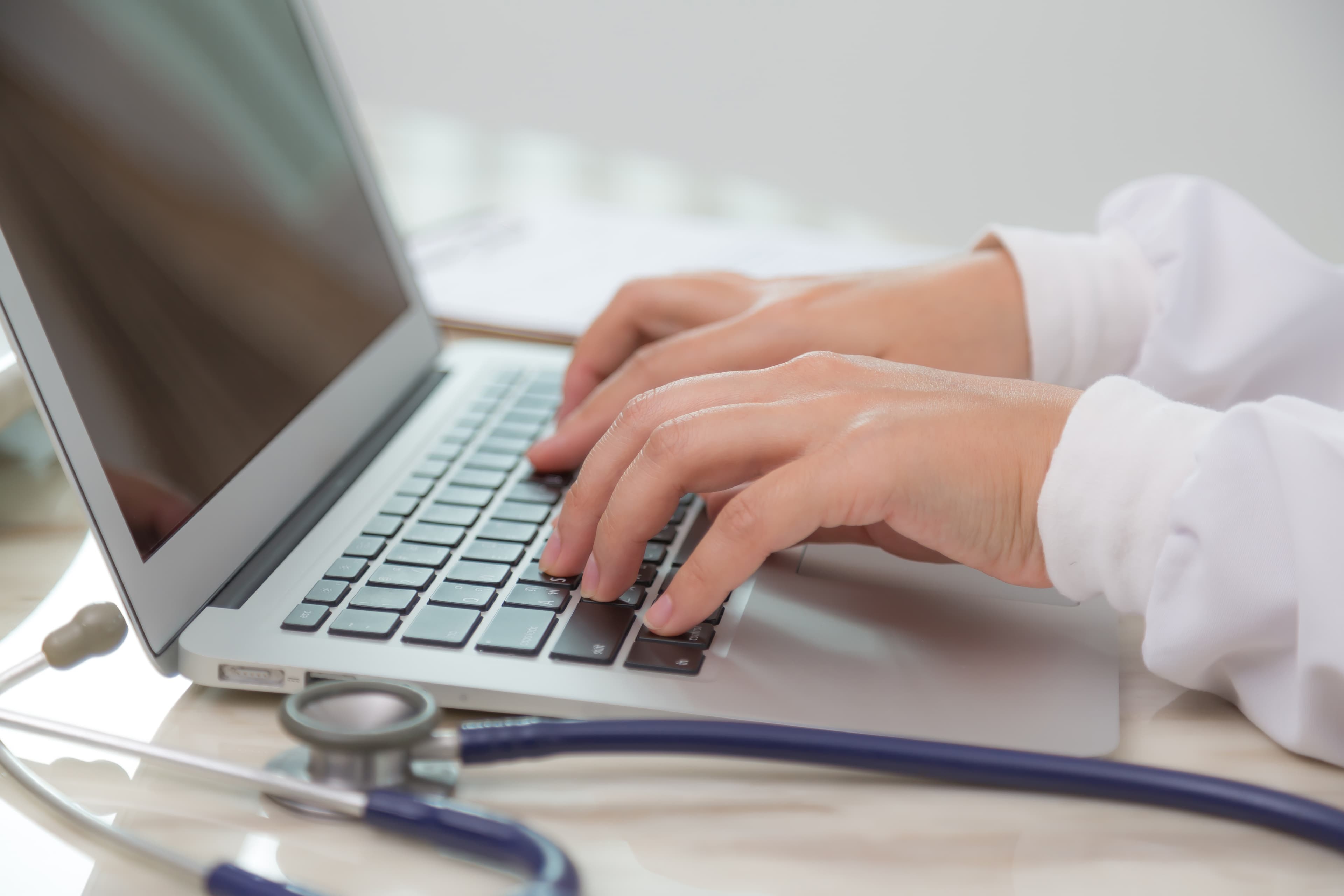 Medical banner with doctor working on laptop